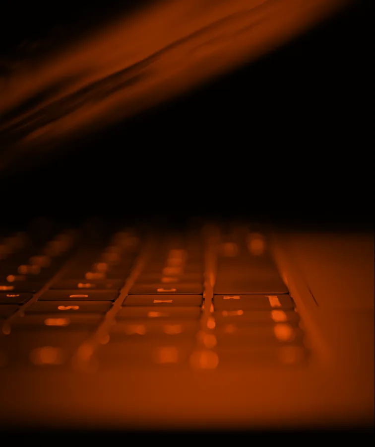 A backlit keyboard in raking orange light.